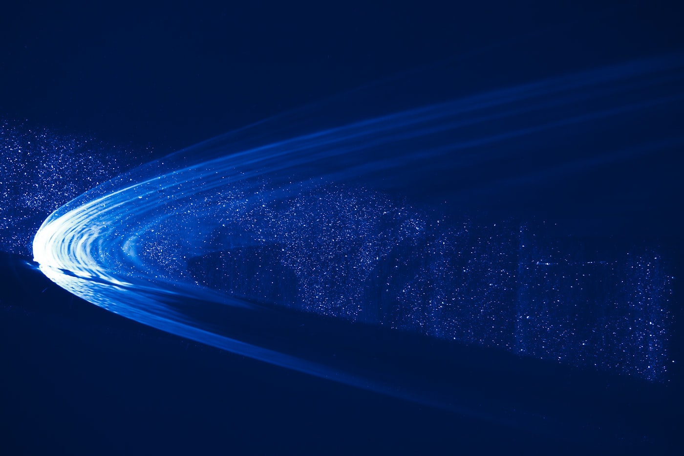 Blue light moving fast through the dark